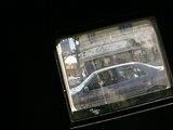 Seen Through the Bulletproof Window of a U.S. Humvee, Iraqis Smile from Their Car Photographic Print