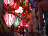 A Lantern Vendor Displays Her Silk Lanterns to a Tourist During the Full Moon Festival Photographic Print