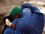 An Afghan Woman Holding Her Child Throws Back Her Burqa to See Her Way Along a Muddy Alley Photographic Print