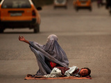 A Girl, 7, Sick with Fever, Lies on a Street Photographic Print