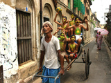 A Rickshaw Puller Carries Supporters of Brazil Soccer Team Photographie