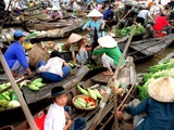 Small Wooden Boats Loaded with Fresh Produce Gather Along a Canal Photographic Print