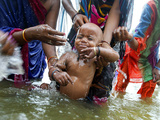 Family Members Give Bath to a Child after a Mundan or Head Tonsured Ceremony Photographie