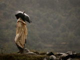 A Pakistani Man Tries to Protect Himself from Heavy Rain Photographic Print