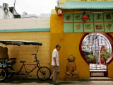 An Unidentified Chinese Man Walks Past the Cuban Wushu Association of Havana's Chinatown Photographic Print