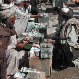 Afghan Money Changers on the Roadside Market Photographic Print