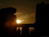 A Man Wearing a Cowboy Style Hat is Silhouetted as He Watches the Sun...