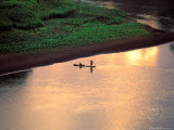 Sunset on Karo Men in a Dugout Raft, Omo River, Ethiopia Photographic Print by Janis Miglavs