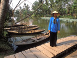 Woman Near Old Boats, Mekong Delta, Vietnam Photographie par Bill Bachmann