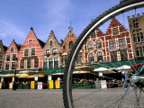 Cafes Through a Bike Wheel, Marketplace in Downtown Bruges, Belgium Photographie par Bill Bachmann