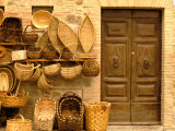 Montalcino, Basket Seller and Wall, Tuscany, Italy Photographic Print by Walter Bibikow
