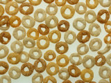 Round Healthy Breakfast Cereal Scattered on a White Surface Fotografická reprodukce Round Healthy Breakfast Cereal Scattered on a White Surface Fotografická reprodukce