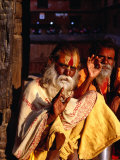 Portrait of Two Sadhus Making Hand Signals in Taumadhi Square, Bhaktapur, Nepal Photographie par Ryan Fox