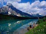 Couple Sitting on Edge of Waterfowl Lake, Banff National Park, Canada Photographic Print by Philip & Karen Smith