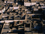 Rooftops of Tibetan Houses, Some with Solar Ovens, Shigatse, Tibet Photographie par Grant Dixon