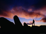 Person Standing on Rocks Silhouetted Against Sunset at Mt. Wellington, Tasmania, Australia Photographie par Gareth McCormack
