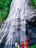 Family Looking Up at Jungle Waterfall, French Polynesia Photographie par Philip & Karen Smith