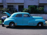 Man Looking in Boot of a Blue 1948 Chevrolet, Vedado, Cuba Photographic Print by Rick Gerharter