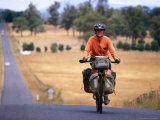 Cyclist on Road from Ormaston to Deloraine, Deloraine, Australia Photographic Print by Trevor Creighton