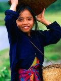 Portrait of Girl Balancing Basket of Herbs, Muang Ngoy, Laos Photographie par Anthony Plummer