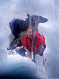 Man Looking into Snow Cave, Maligne, Jasper, Canada Photographie par Lee Foster