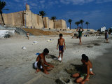 Children Playing On Beach In Front Of Restored Fort Ribat, Monastir, Tunisia Lámina fotográfica por Damien Simonis