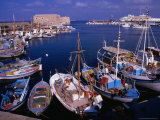 Fishing Boats in Harbour with Venetian Fortress Herakleion in Distance, Greece Photographie par Wayne Walton