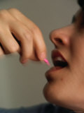 Woman Taking Pink Pill, Canada Photographie par Rick Rudnicki