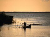 Fisherman Checking Nets at Dawn on Danube Delta, Tulcea, Romania, Photographie par Diana Mayfield