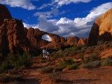 People Standing in Front of the Skyline Arch, Arches National Park, USA Photographic Print by Brent Winebrenner