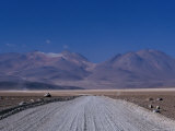 Dirt Road with Mountains Behind Near Lake Verde, Lake Verde, Bolivia Photographic Print by Brent Winebrenner