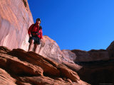 Hiker Standing on a Ledge at Lake Powell, Utah, USA Photographic Print by Cheyenne Rouse
