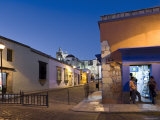 People Stood in Shop Doorway at Dusk, Oaxaca, Oaxaca State, Mexico Photographic Print by Peter Adams