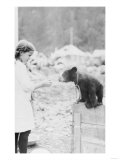Girl Playing with Bear Cub in Seward, Alaska Photograph - Seward, AK Prints
