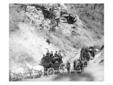 Procession of Stagecoaches Coming down Mountain Road Photograph - Deadwood, SD Poster