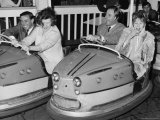 Racing Drivers Graham Hill and Jim Clark Enjoying a Dodgem Ride Photographic Print