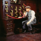 Benny Hill Comedian November 1985 Sitting Speaking Into Hose Machine Wearing Cap Photographic Print