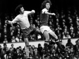 Football Player Charlie George Jumps with Roy Mcfarland For the Ball at Highbury Photographie