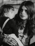Black Sabbath Lead Singer Ozzy Osbourne Holding a Child Lámina fotográfica