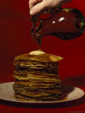 Hand Pours Syrup onto a Stack of Pancakes Photographic Print by Brian Gordon Green