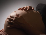 Pregnant Woman Strokes Her Baby Through Her Belly Photographic Print by Paul Damien