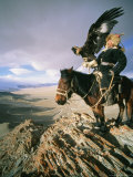 Hunter on Horseback Atop a Hill Holding a Golden Eagle in Mongolia Photographic Print by David Edwards