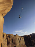 Base Jumper Leaping with a Parachute From the Tombstone Formation Photographic Print by Jimmy Chin