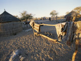 San Bushman Village of Thatch Huts Photographic Print by Joy Tessman