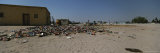 Trash Litters the Ground in Front of a Bar in Namibia Photographic Print by Joy Tessman