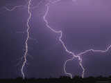 Dramatic Bolts of Lightning Crisscross a Night Sky Photographic Print by Carsten Peter