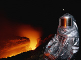 Scientist in Full Helmet and Thermal Suit Collects Lava Samples Photographic Print by Carsten Peter