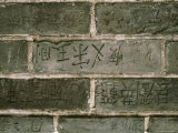 Chinese Graffiti Carved into Bricks on the Great Wall of China Photographic Print by Todd Gipstein