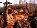 Rusty Old Truck Strung with Christmas Lights, with Santa Claus at Wheel Photographic Print by Judy Bellah