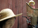 Infant in Traditional Backpack Photographic Print by Gavin Quirke